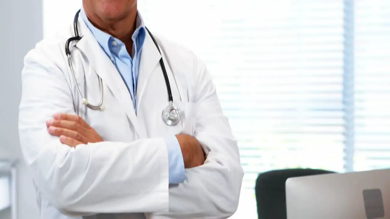 Portrait of doctor standing with arms crossed