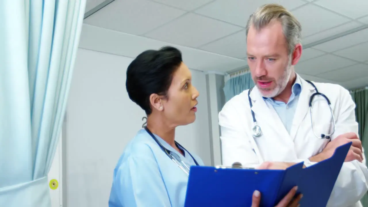 Doctor discussing reports with colleague