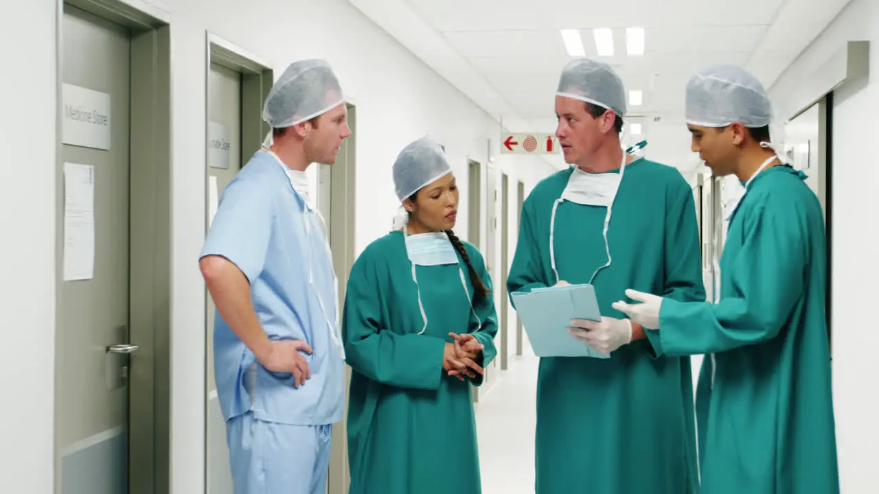 Male surgeons discussing over medical reports