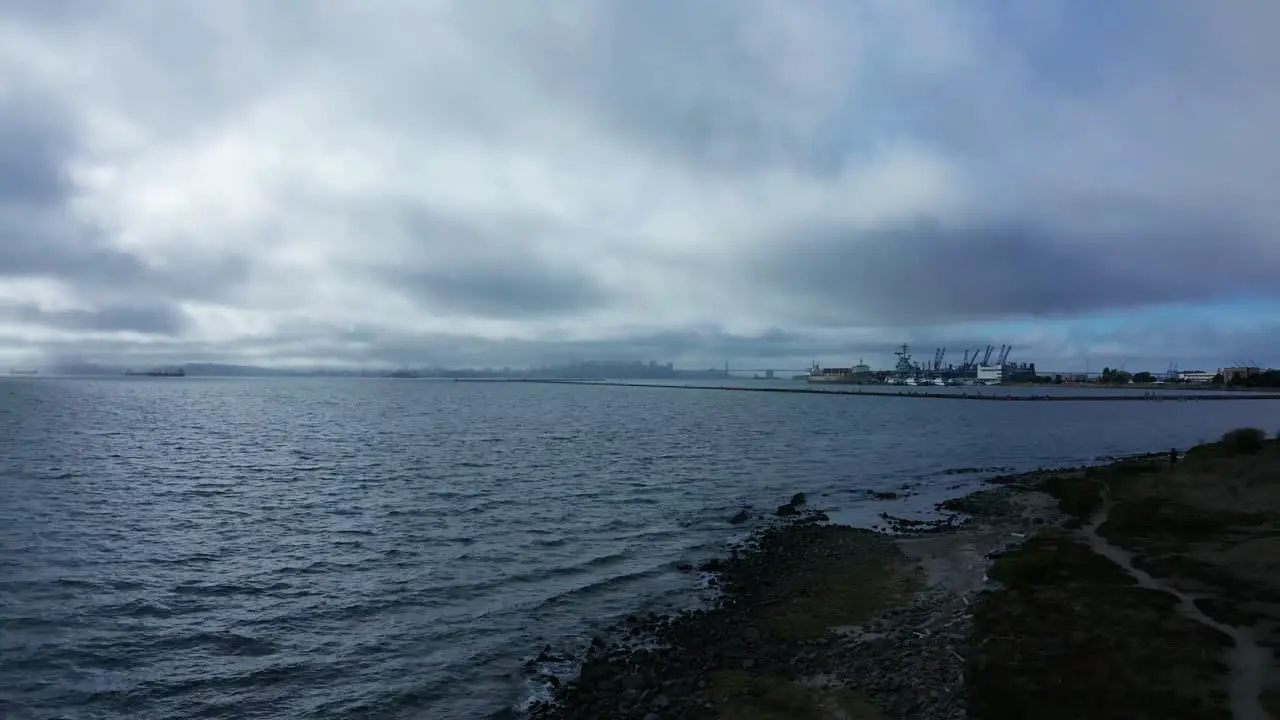 Sun streaks break the clouds on a cloudy marina day near the Naval base