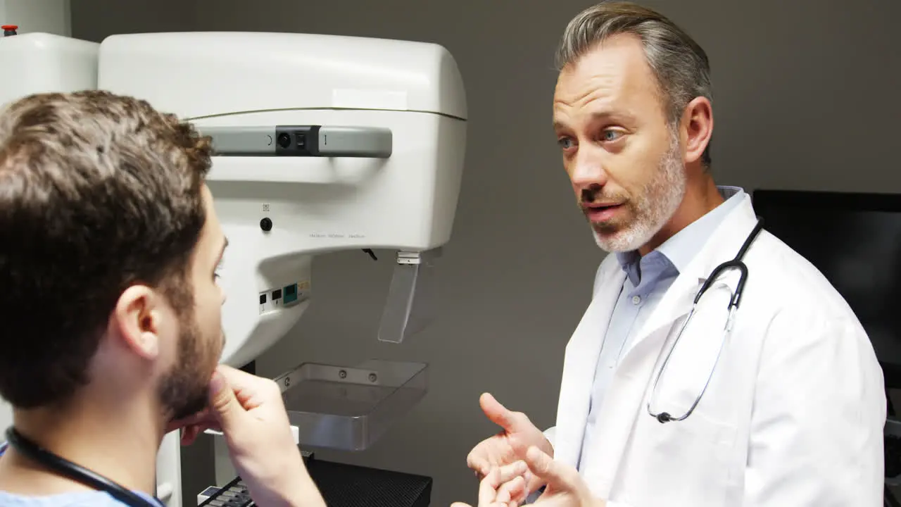 Male doctor and colleague interacting with each other