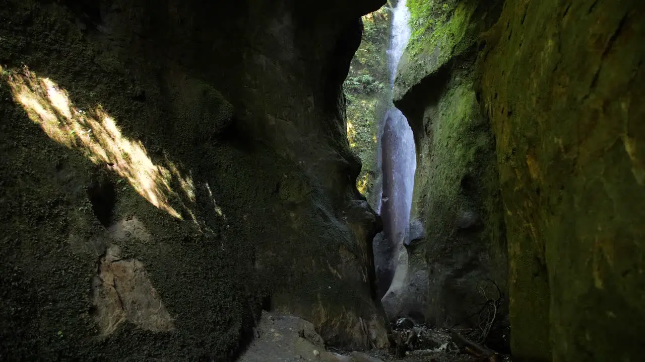 Wide slow motion shot of a hidden waterfall in a canyon