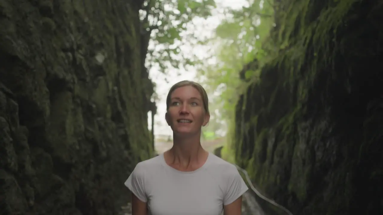 Woman walking through mysterious rock canyon Madeira Balcoes Hike portrait shot