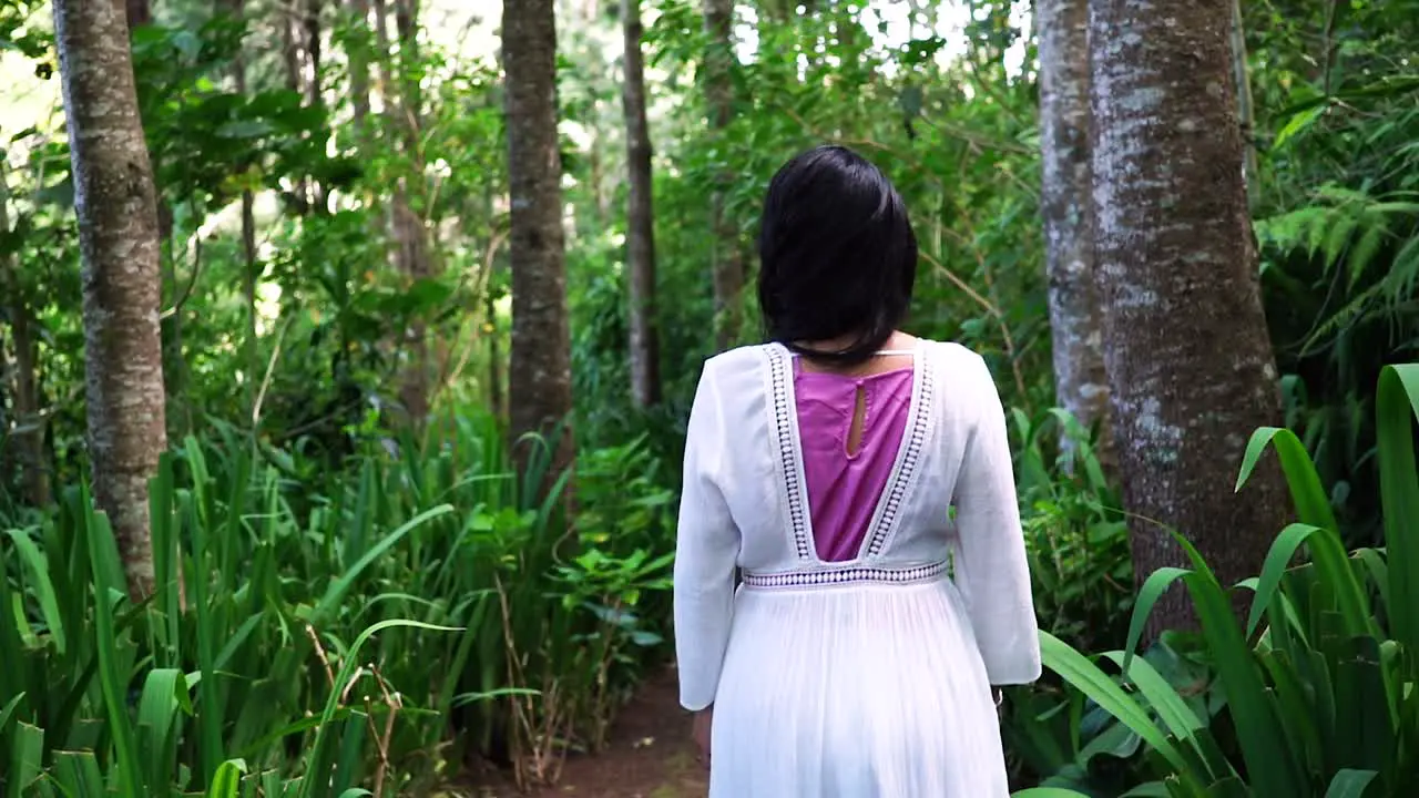 Following a woman walking into the forest