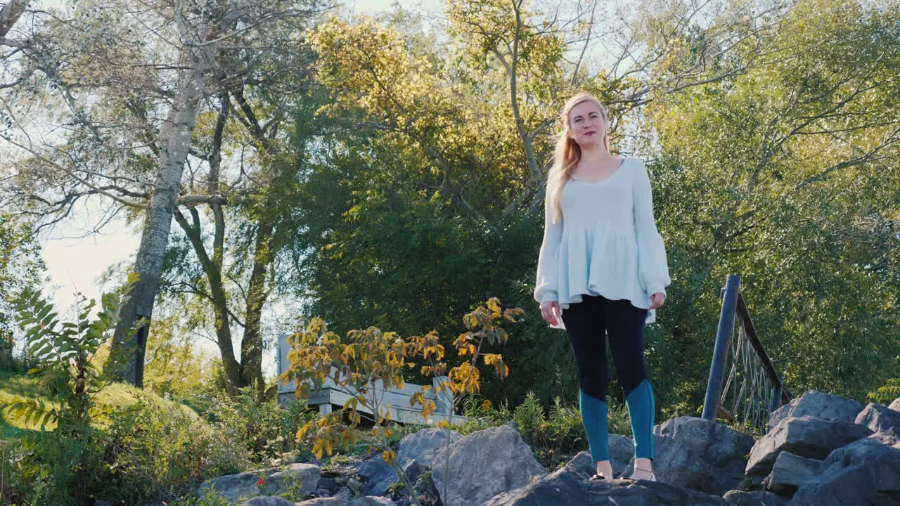 Woman on Rocks Looks Into Distance