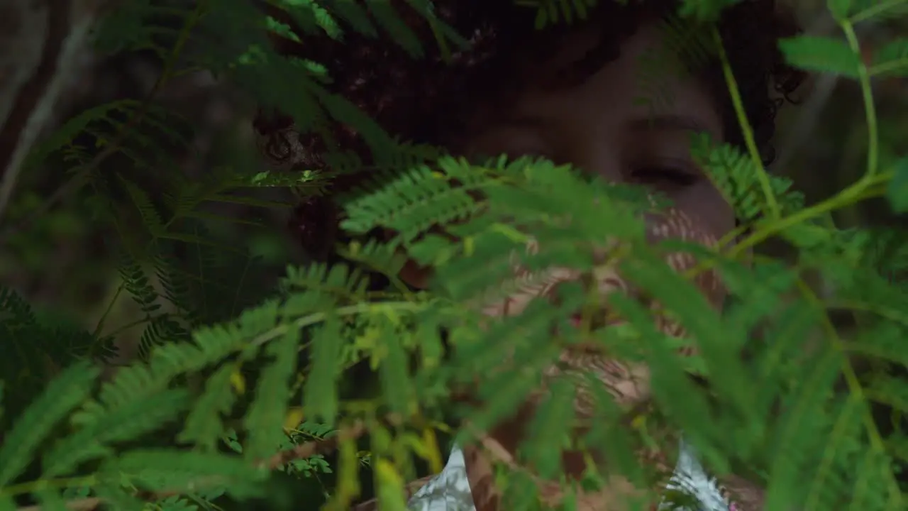 Facial close up of a brown eye girl with leaves in the foreground