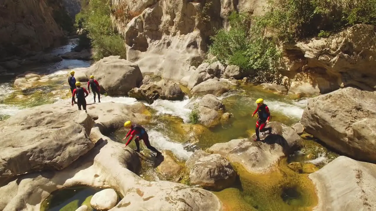 People walking over river on rocks-1