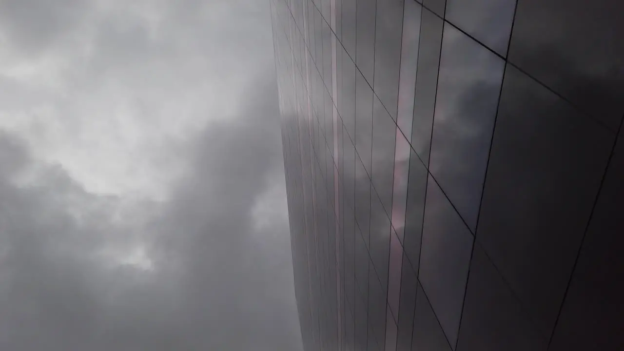 Dark cloudy sky reflected in a dark glass building