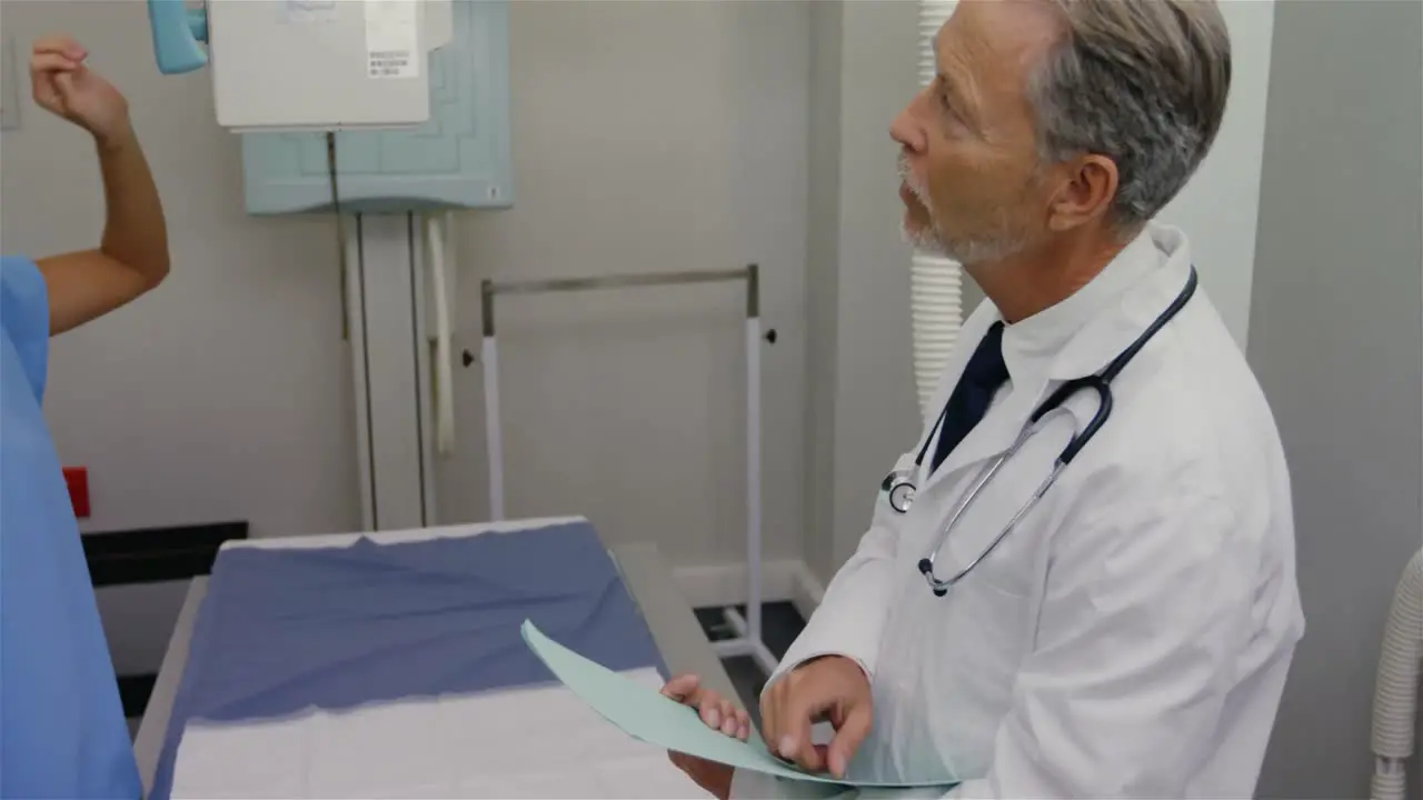 Surgeon and colleague interacting with each other in medical room