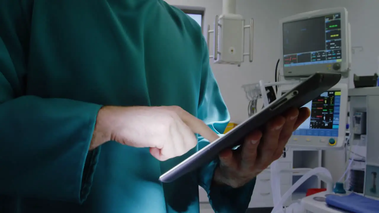 Surgeon using digital tablet in operation room