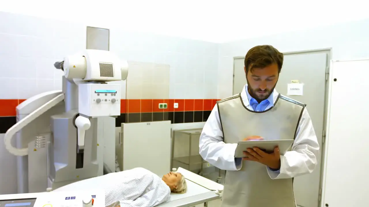 Male doctor using digital tablet in x-ray room