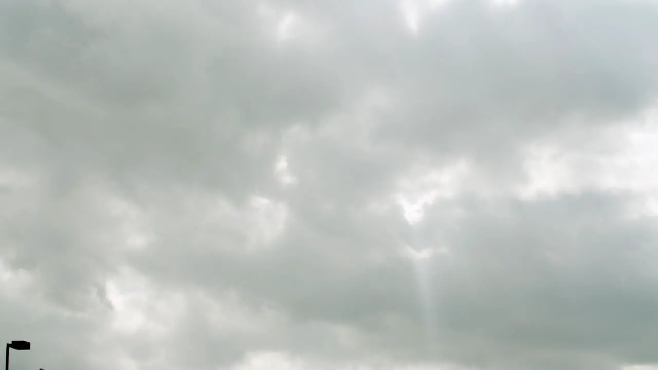 Sun singing through the storm clouds in a parking lot