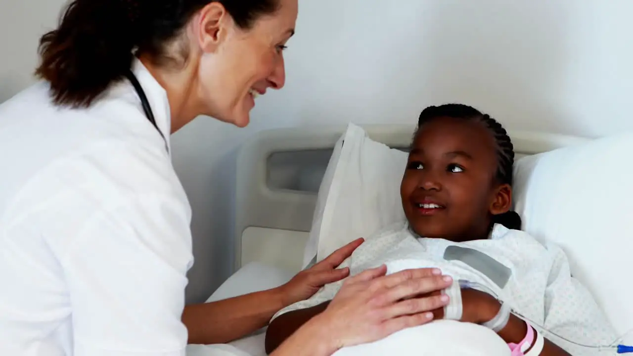 Female doctor consoling sick girl