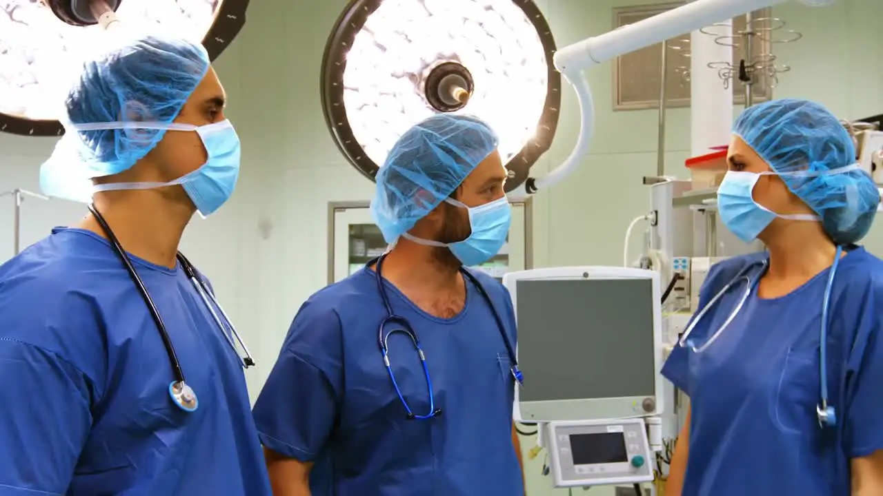 Male and female surgeons interacting with each other in operation room