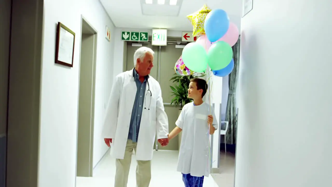 Doctor interacting with patient while walking in corridor