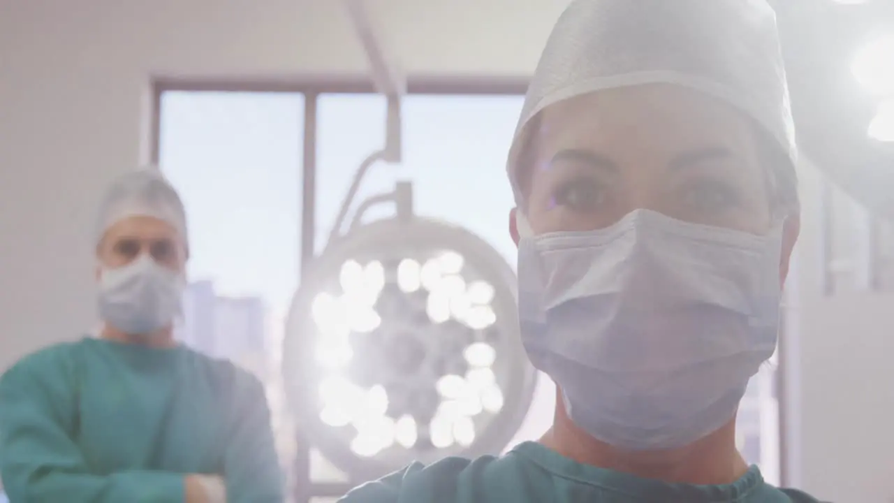 Portrait of surgeons standing with arms crossed in operation room