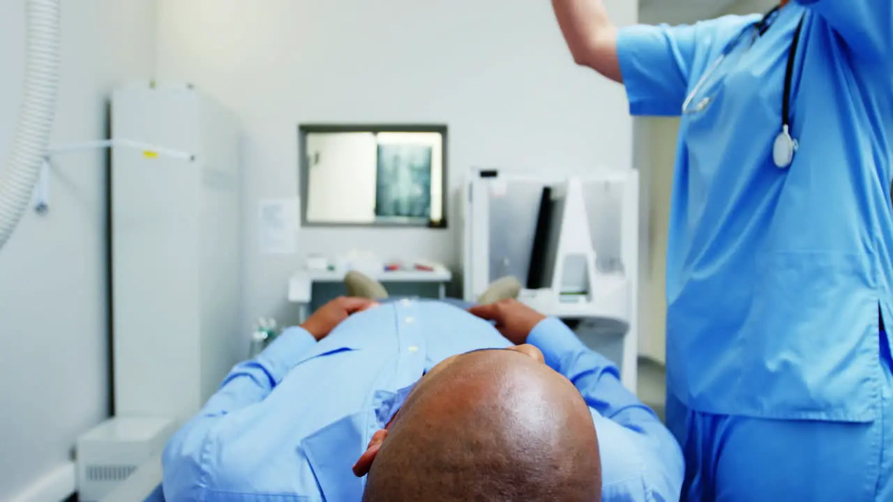 Female doctor sets up the machine to x-ray a patients chest