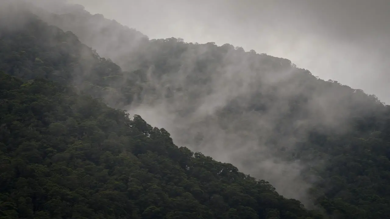 Misty mountains above a beautiful majestic valley with clouds forming close up shot