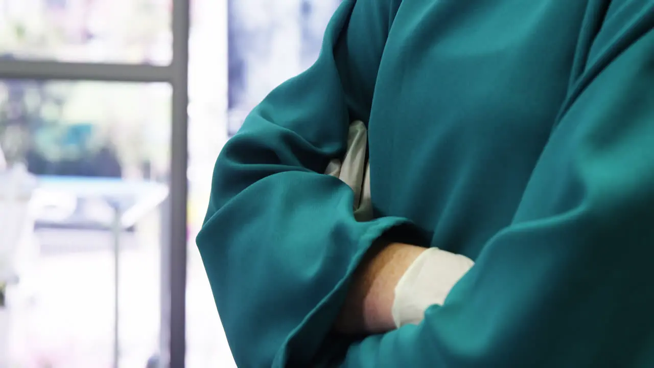 Portrait of female surgeon standing with arms crossed