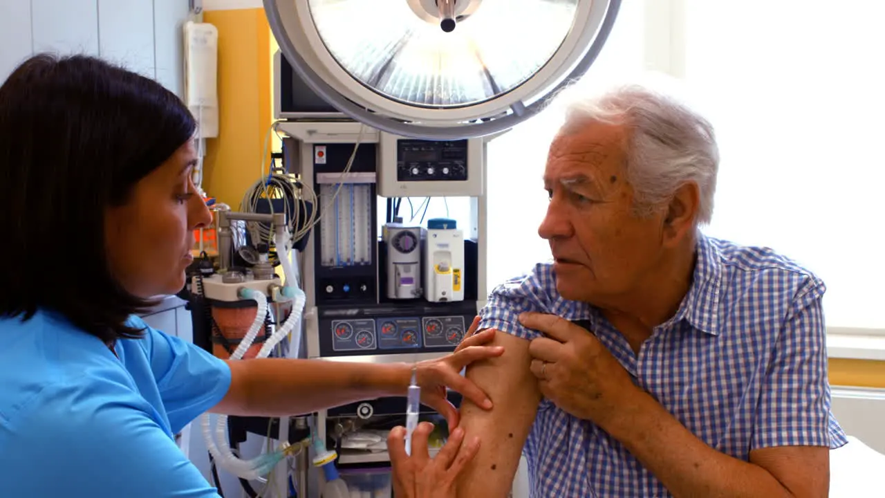 Female doctor giving an injection to a patient