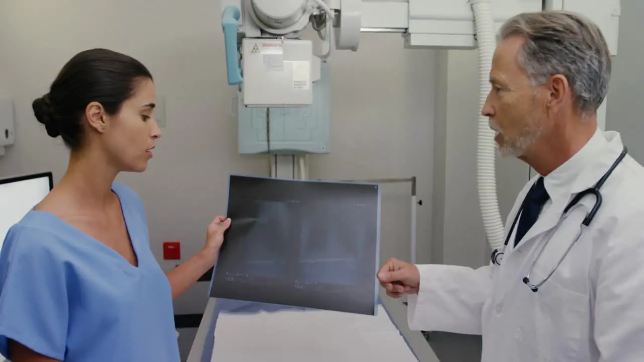 Surgeon and colleague discussing over an x-ray