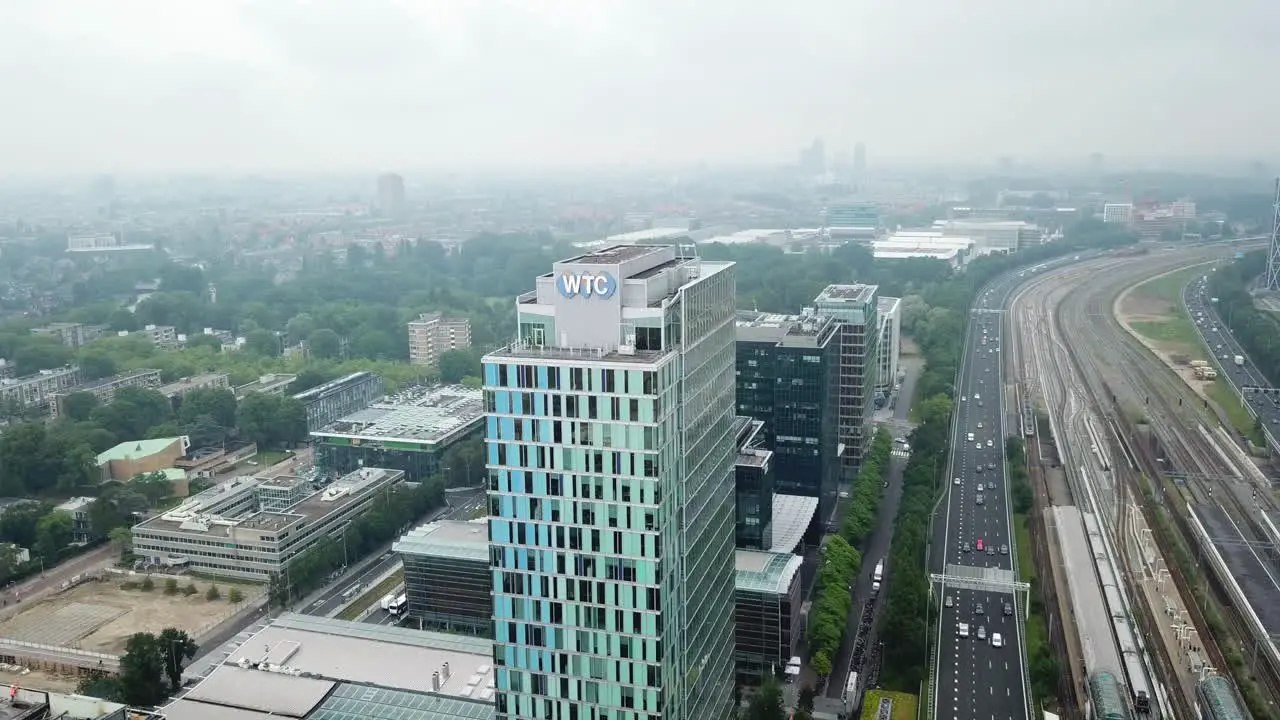 WTC World Trade Center Amsterdam zoom towards WTC Building with highway and railroad on the right