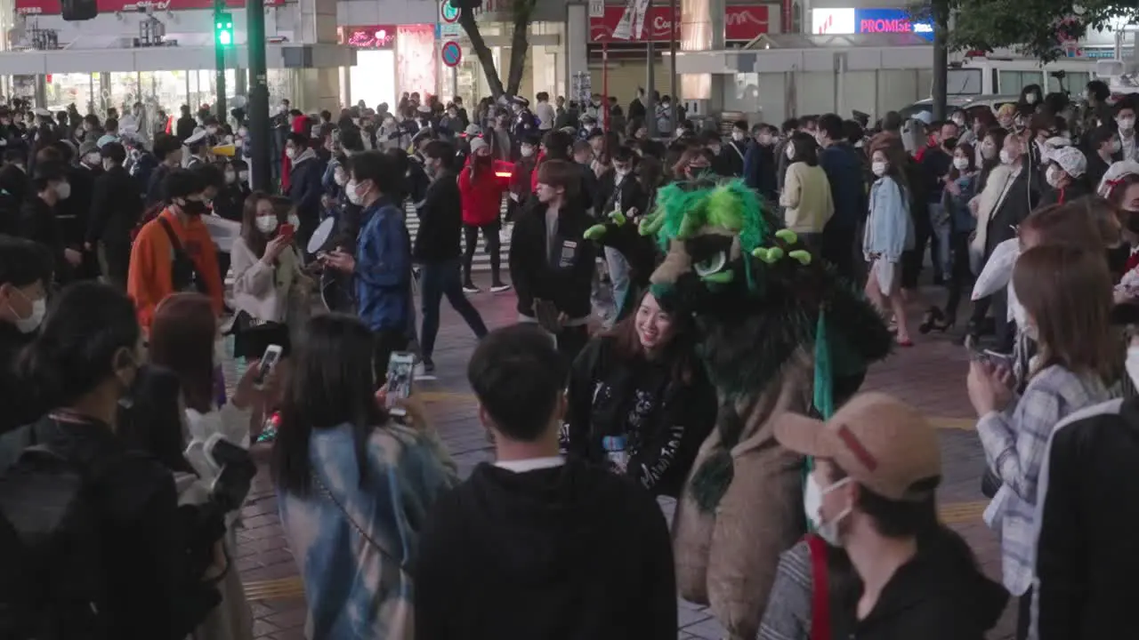 Japanese Woman Taking Picture With A Person In Scary Halloween Costume At Shibuya Crossing On Halloween Night hyper-lapse