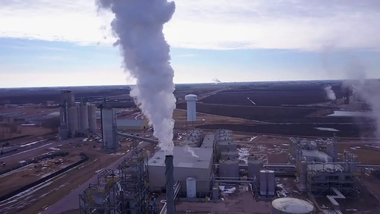 An aerial shot over an oil refinery spewing pollution into the air 1