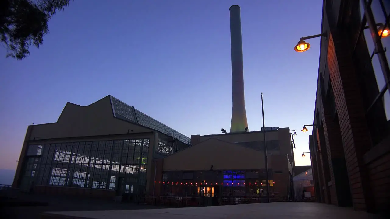 Wide shot of a large warehouse or factory at dusk or sunset 2