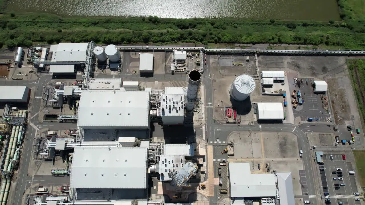 Rising drone view Grain CHP Power station Kent UK chimney storm damaged