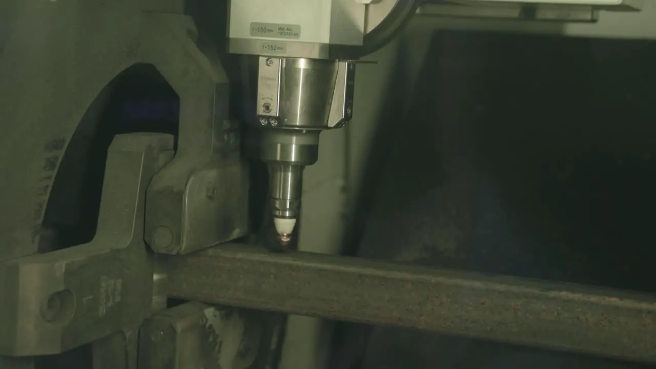 Fast footage of a laser cutting machine cutting through a steel frame pipe