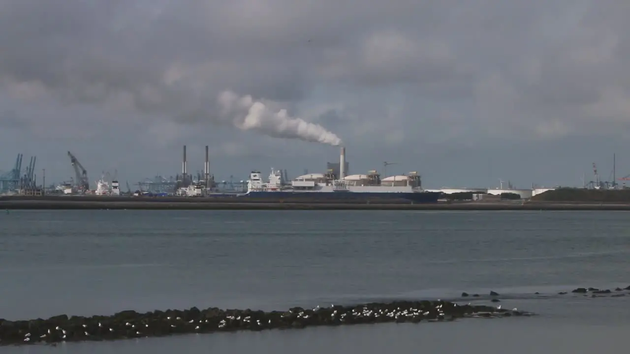 Commercial docks and ship viewed across the waterway from the Hook of Holland