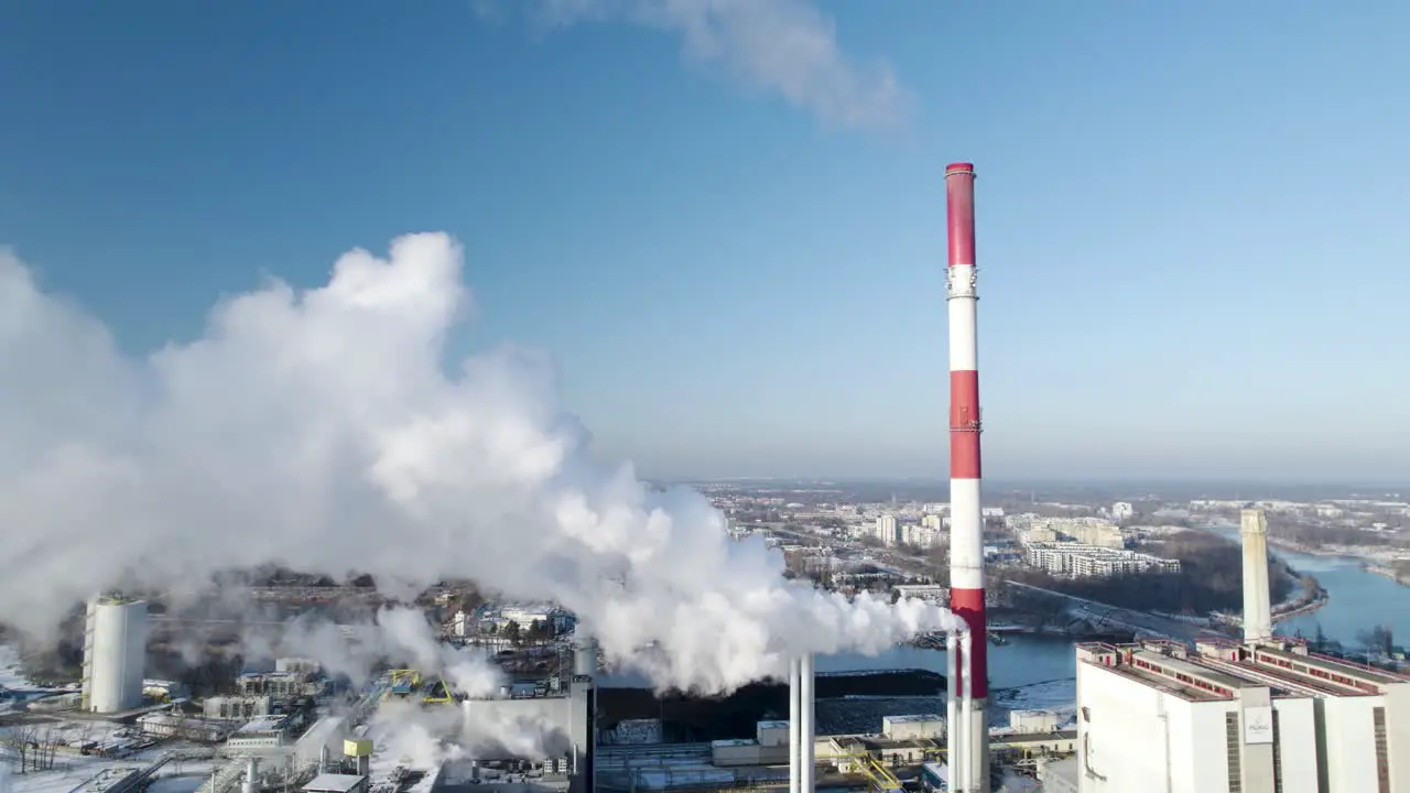 Aerial dolly back view from heat power plant near the city centrum