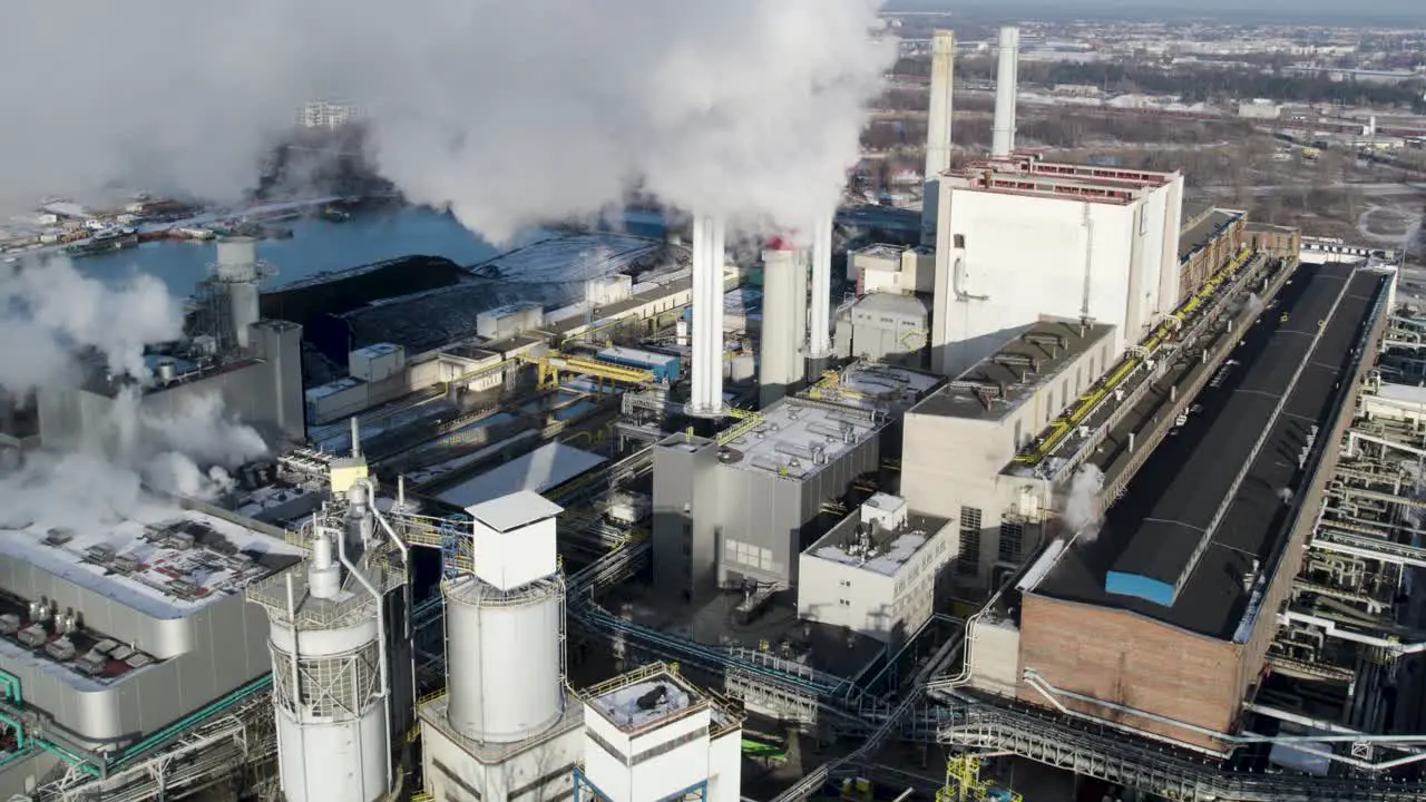 Steam rising from heat energy power plant during winter aerial