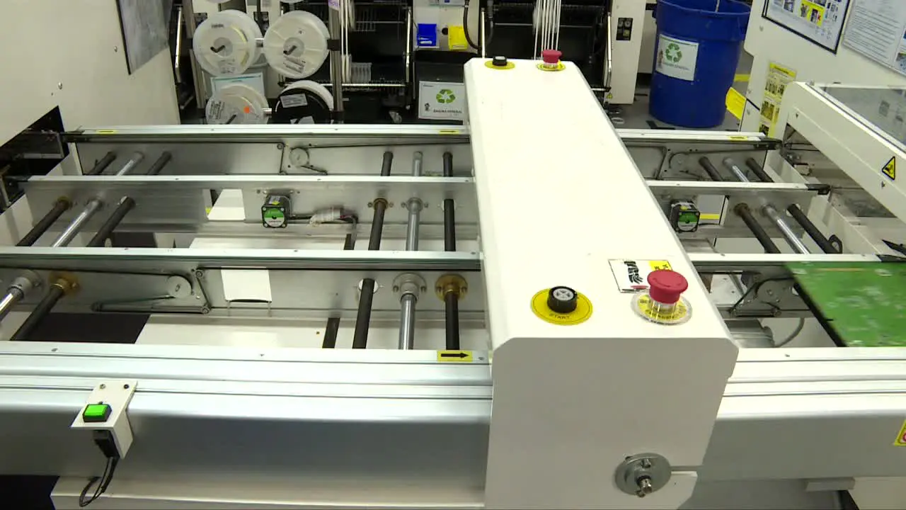 automated machine passing microchip plates inside an it factory