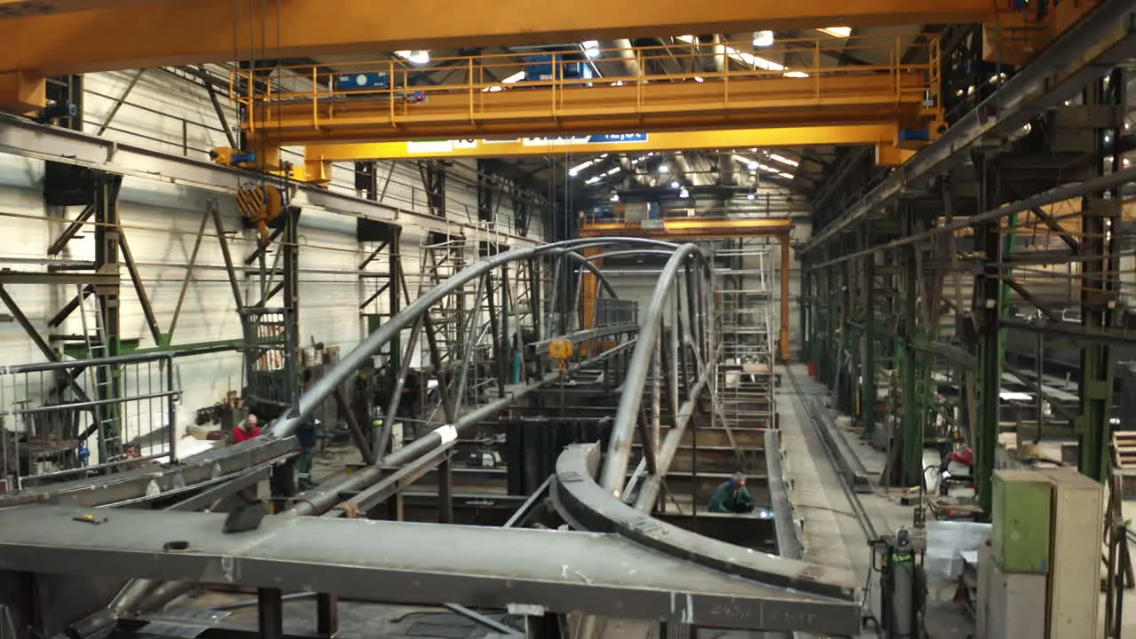 Workers preparing new bridge in Brno steelworking factory welding hall