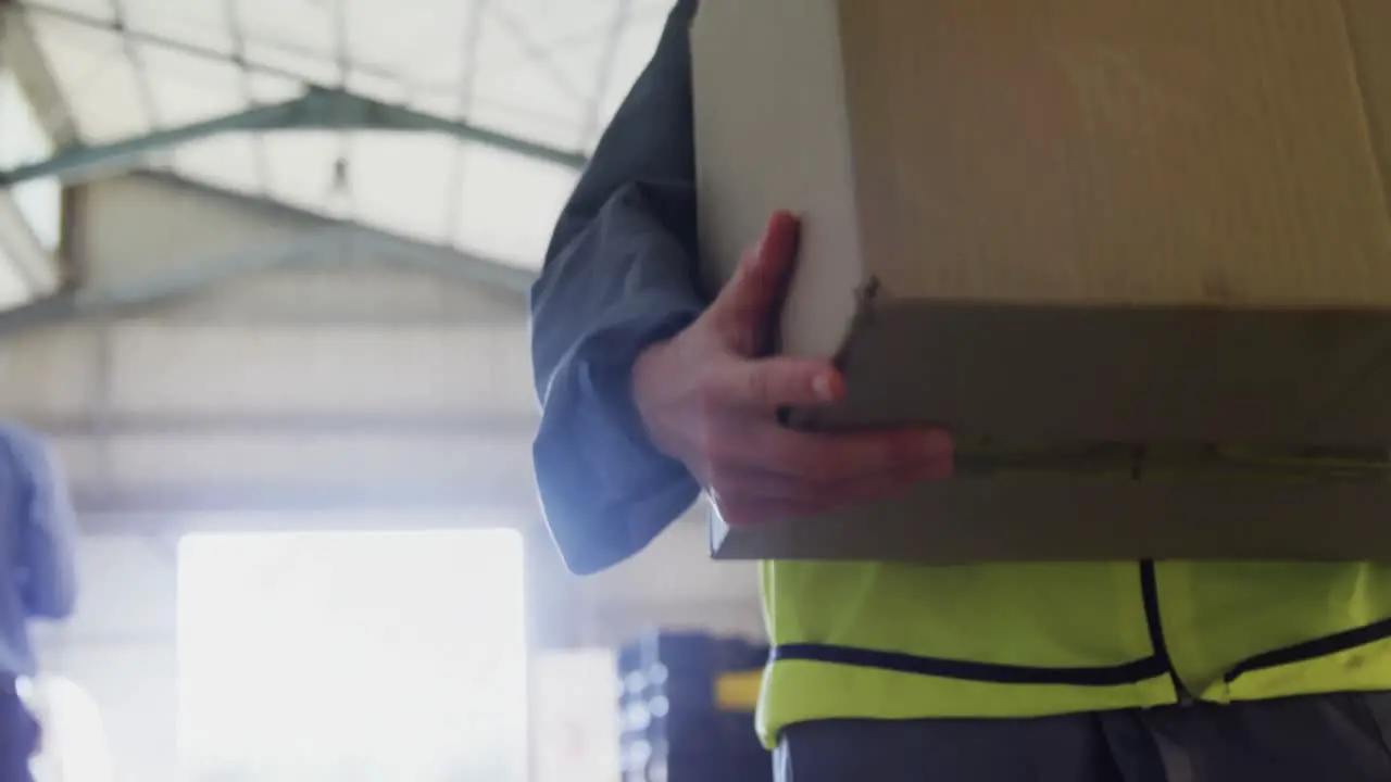 Worker walking with card board box in oil factory 4k