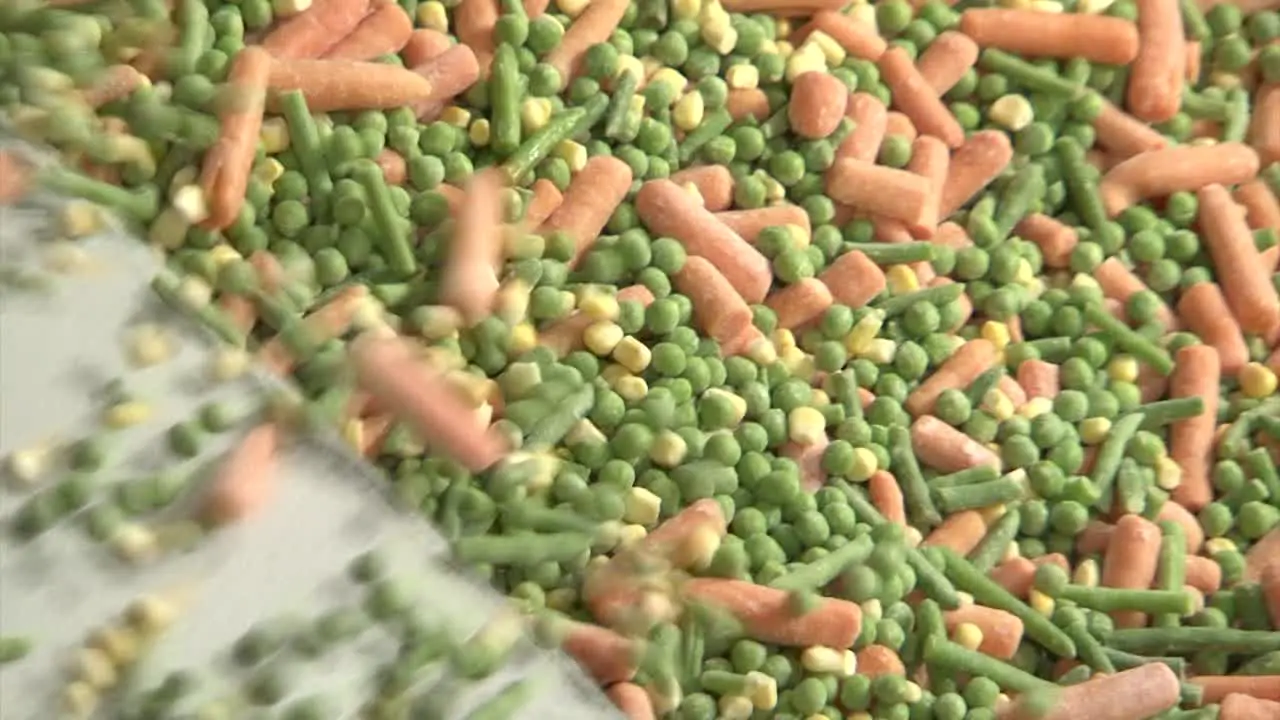 Production line with frozen peas and carrots