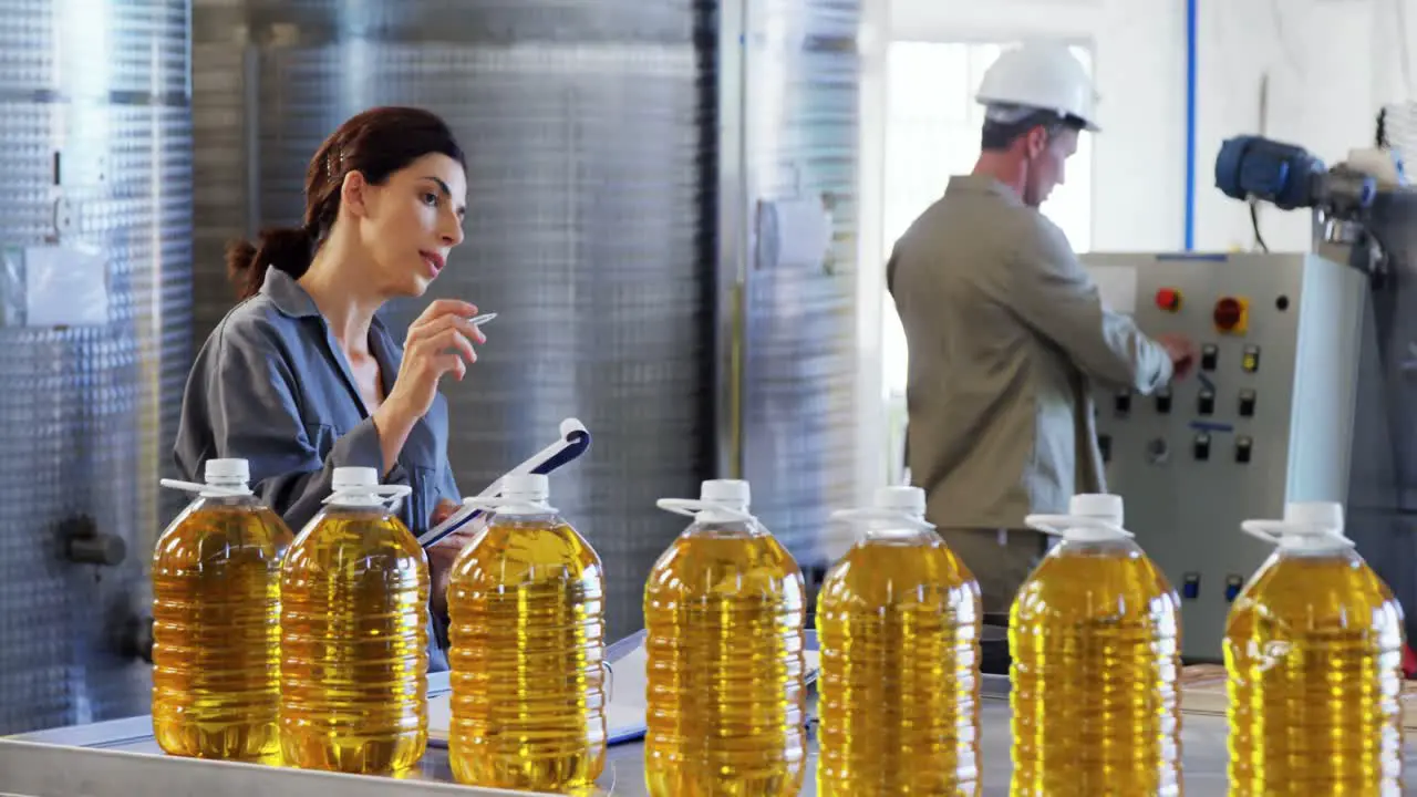 Female worker working in oil factory