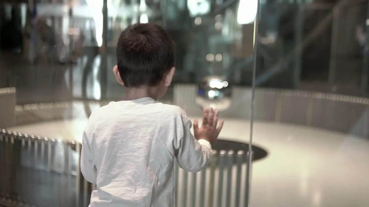 Boy at the science museum watching the Foucault pendulum