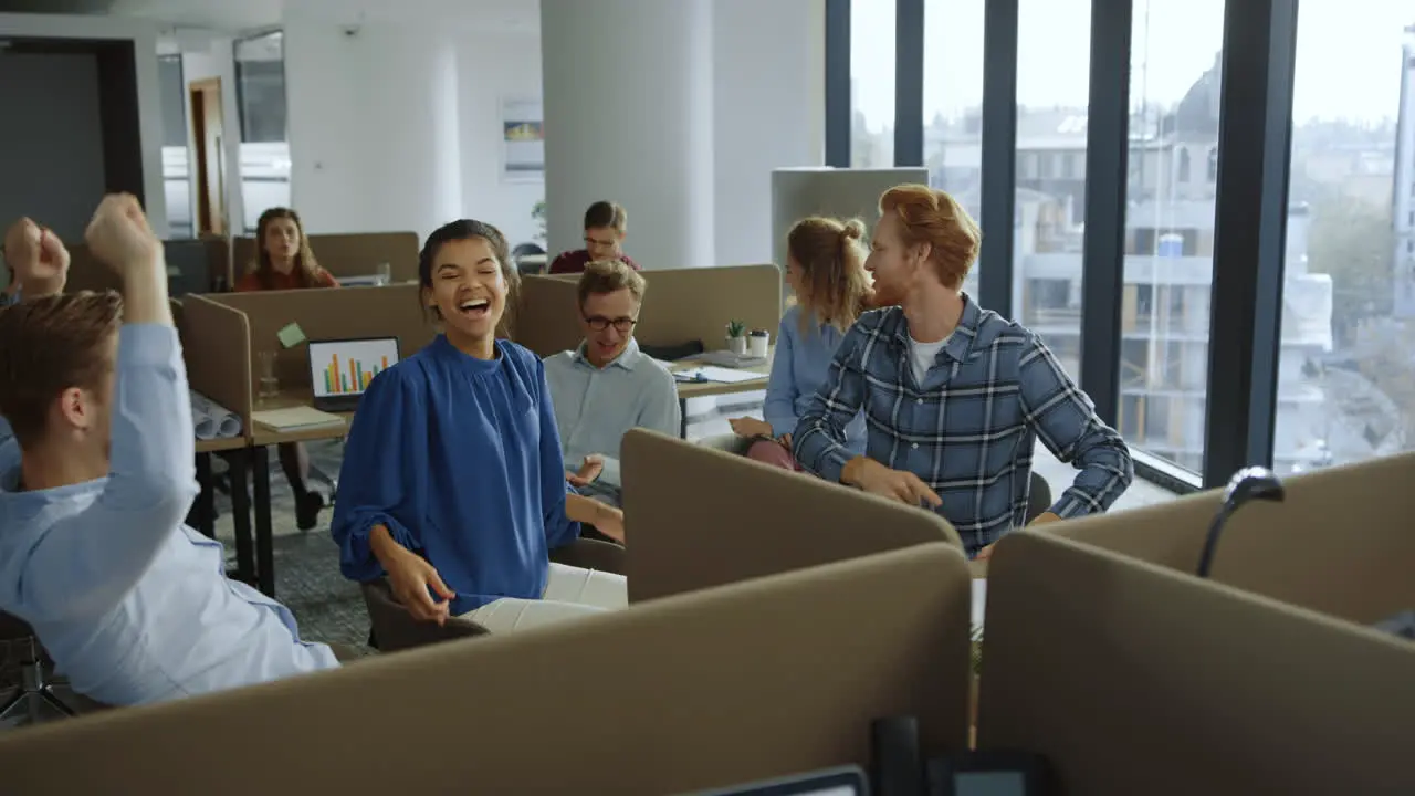 Business team enjoying victory in open space Colleagues gesturing hands