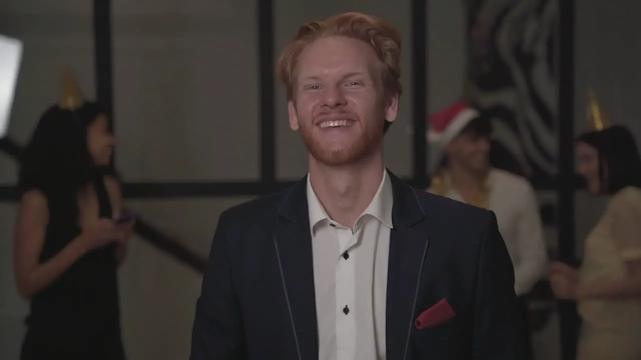 Young Happy Man Looking At The Camera And Toasting At New Year's Eve Party