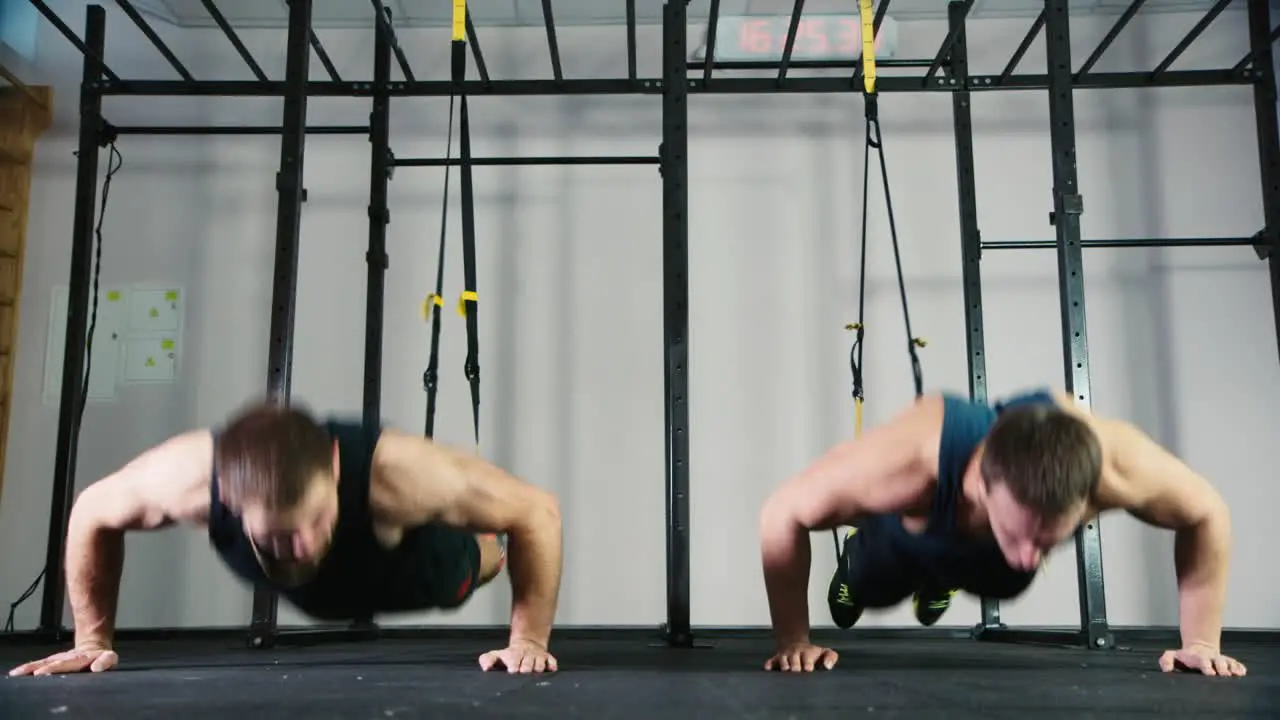 Two athletes do strength exercises in the gym