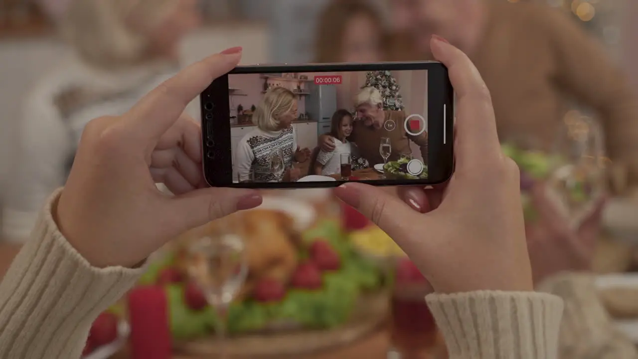 Hands With A Phone Recording A Video