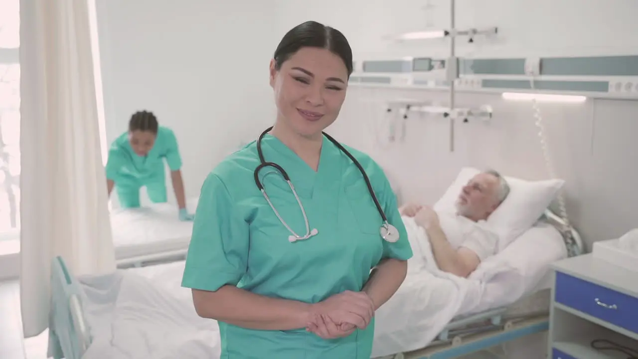 Woman Nurse Looks Directly Into The Camera And Smiles