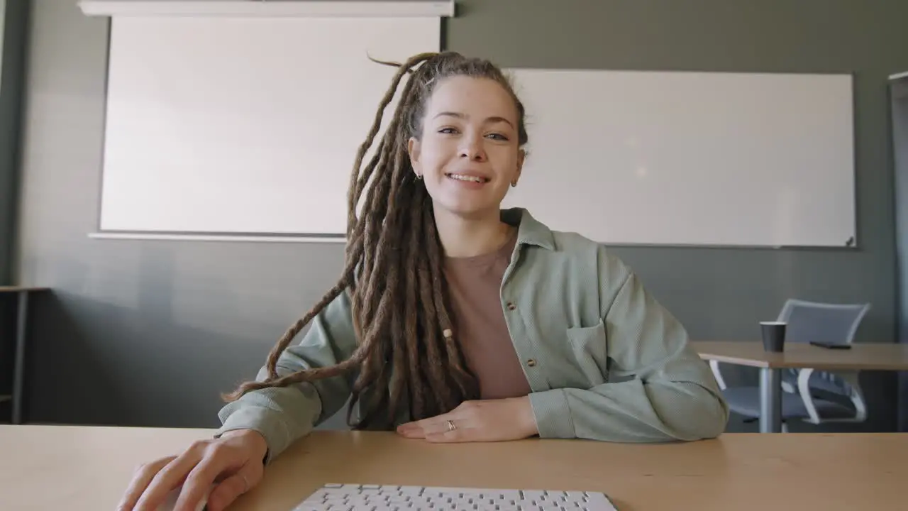 Young Girl With Dreadlocks Making A Presentation Sitting At A Table In Class