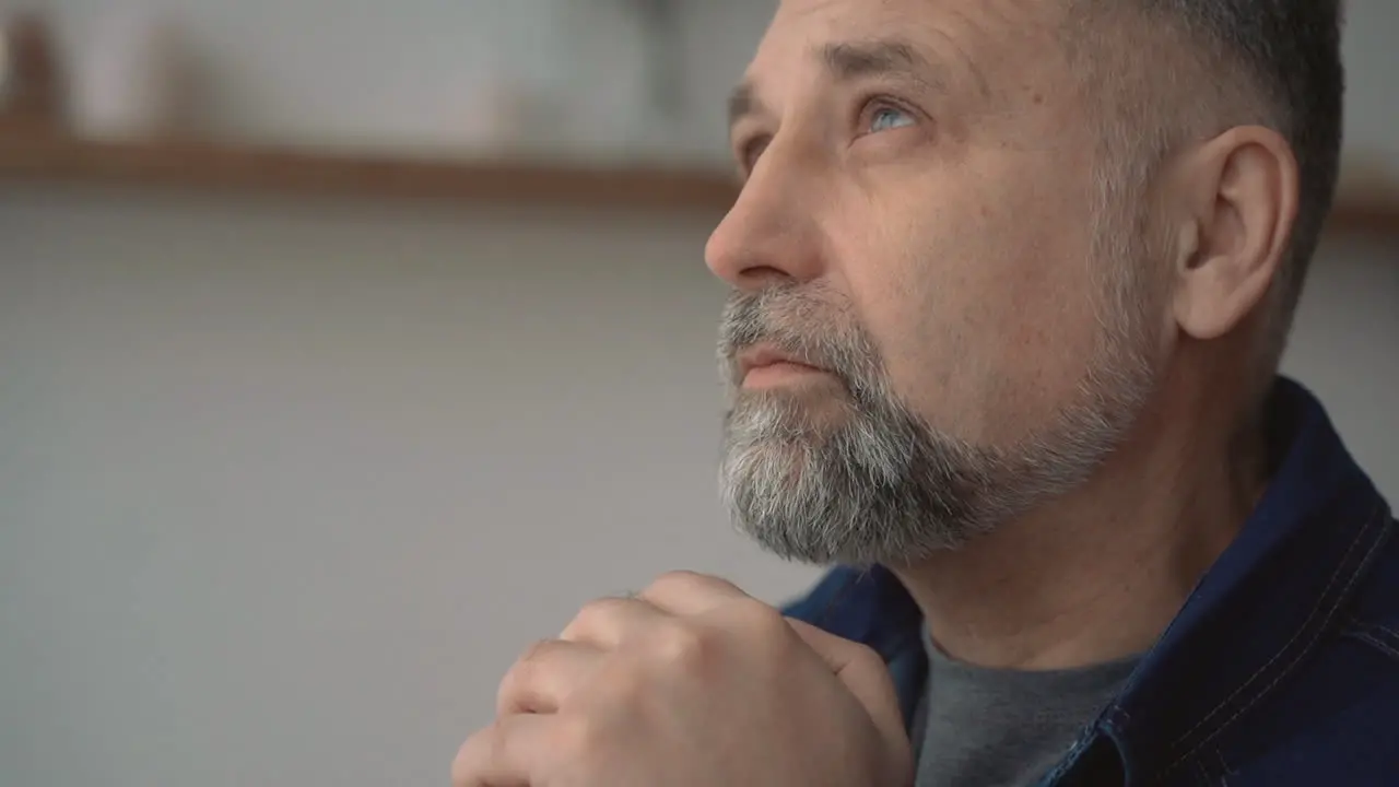 Portrait Of Mature Man Serious Worried Thinking And Praying Indoors At Home