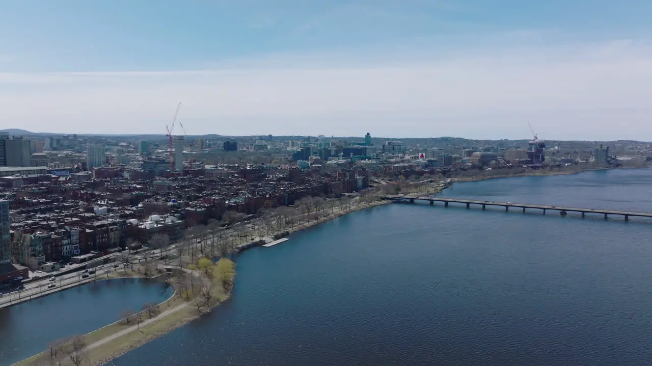 Aerial view of residential and industrial neighbourhood along Charles river Busy multilane road on waterfront Boston USA