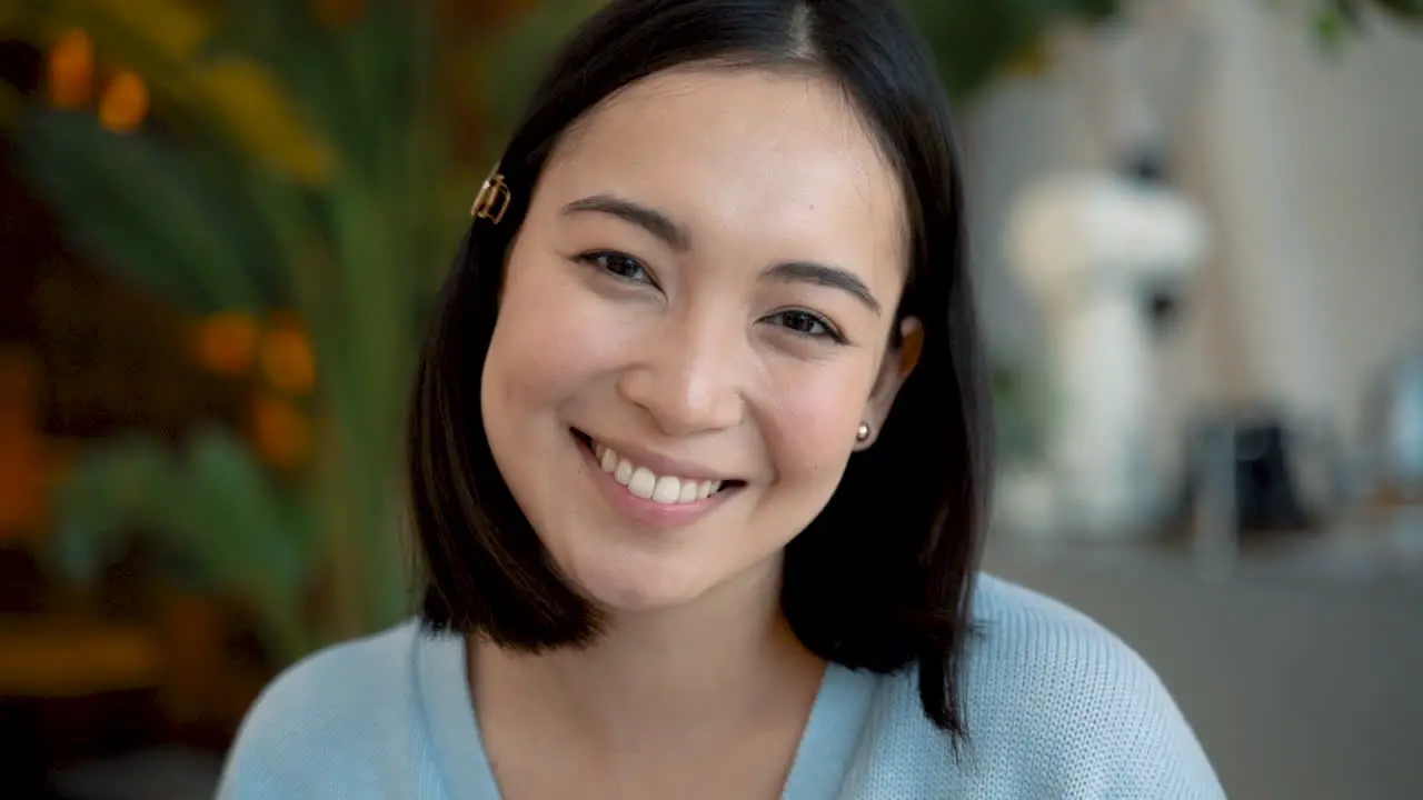 Beautiful Young Female Looks Directly Into The Camera And Smiles