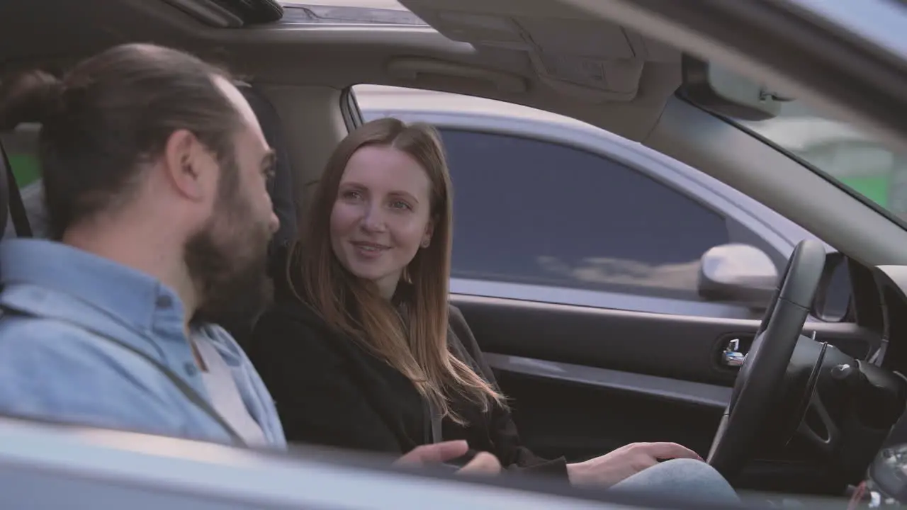 A Very Happy Bearded Man And A Very Happy Beautiful Woman Take A Selfie Inside A Car